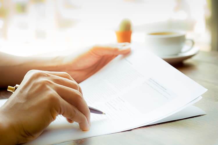 Filling out forms on kitchen table